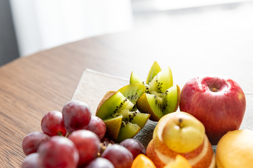 fresh mixed fruits on plate.Delicious fruits.Fruit tray as healthy food for party and holidays table.