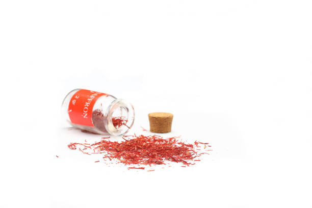 istock saffron poured from a little glass bottle on white background 1340118359