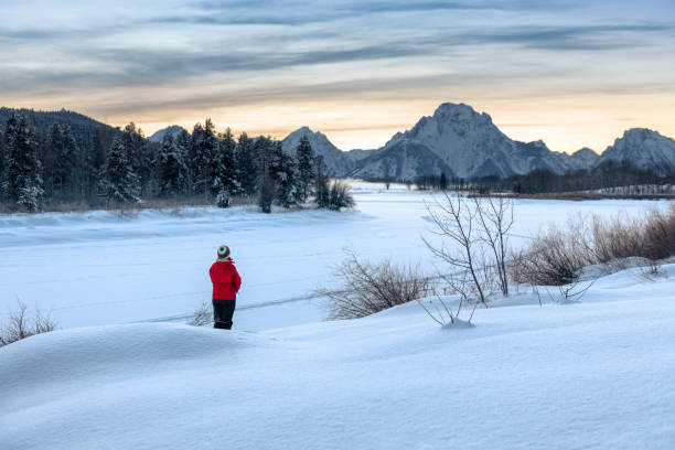 Woman hiking by Grand Teton National Park Woman hiking by Grand Teton National Park in Wyoming snake river valley grand teton national park stock pictures, royalty-free photos & images