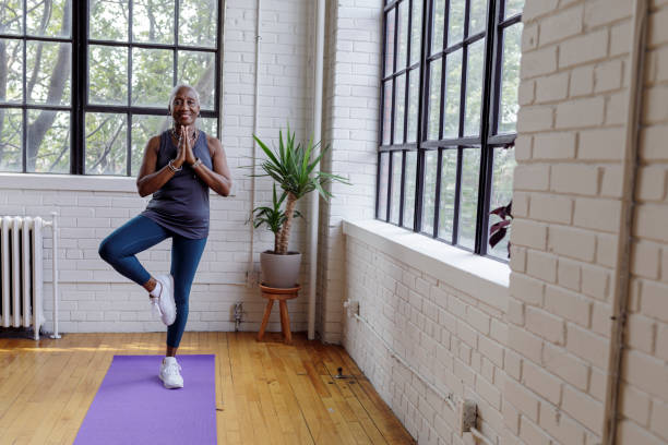 istock Active senior woman doing yoga at home 1340124910