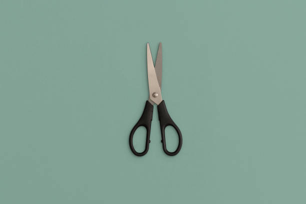 istock Scissors on a green background. Top view. Flat lay. Back to school concept. School stationery 1340125625