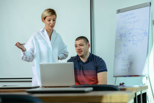 istock Two office workers. Teacher and student. Two people working together. Mobbing at the workplace. 1340128074