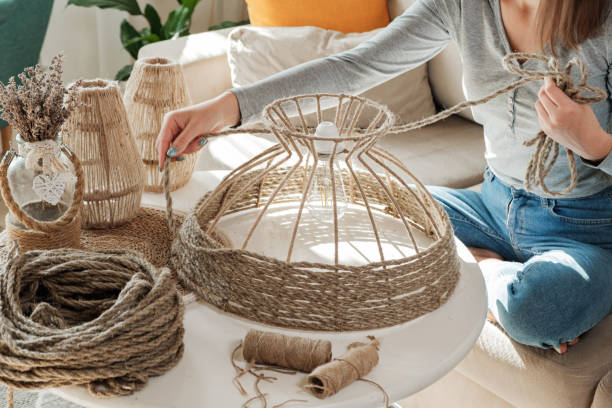 istock Woman makes handmade diy lamp from jute rope 1340131221