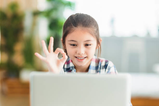 istock Happy student girl study online on laptop.Showing ok gesture. 1340134001