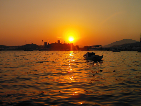 sunset with seascape view in Bodrum town of Mugla city in Turkey with a lot of sea vehicles and coast details for travel destinations coast harbor resting touristic places concepts