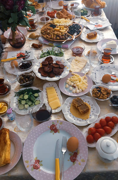 vertical view of a breakfast table with fried eggs, pastry, kashar cheese, stuffed green pepper, red beet, olive oil and fruits no people healthy vegetable eating house interior food concepts