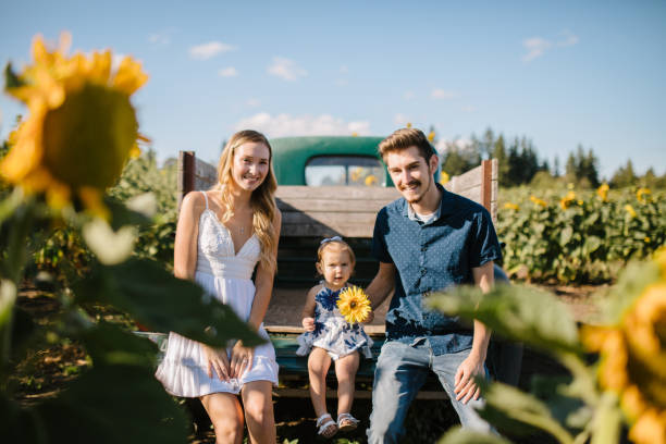 istock Cute Young Family In Cornfield 1340137271