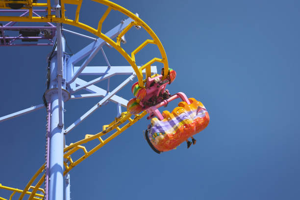 istock people riding on a roller coaster at an amusement park 1340140040