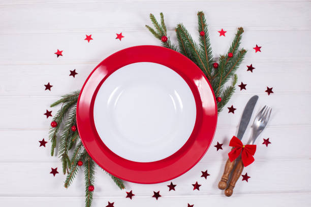 istock Christmas Table Setting with fir branch and red decorations on white background 1340142638