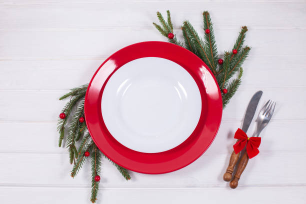 istock Christmas Table Setting with fir branch and red decorations on white background 1340142686