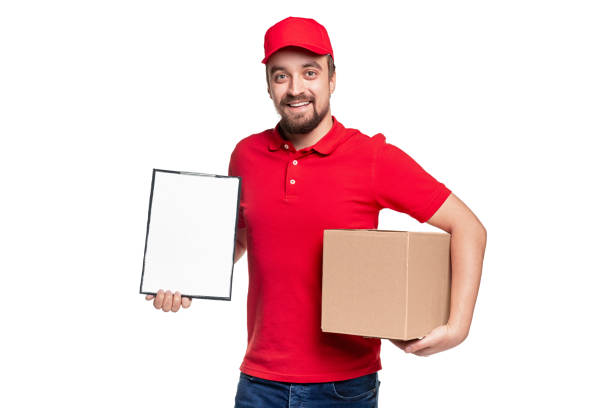istock Happy delivery man with parcel and clipboard 1340145438