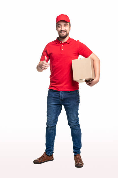 istock Delivery man with parcel showing thumb up on white background 1340145441