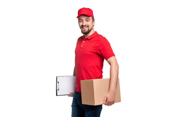 istock Smiling courier with carton box and clipboard on white backgroun 1340145444