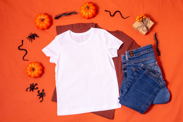 istock White t-shirt mockup and blue jeans on orange halloween background 1340148046
