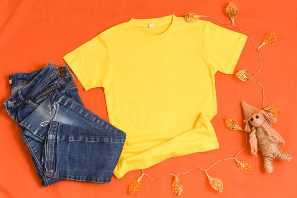 istock Yellow t-shirt mockup on orange fall background 1340148054