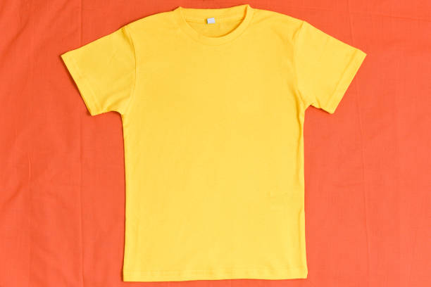 istock Yellow t-shirt mockup on orange fall background 1340148055