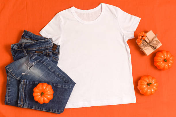 istock White t-shirt mockup and blue jeans on bright orange background 1340148077