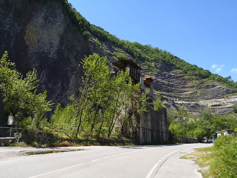 An old factory under a stone cliff in Garfagnana, Lucca province - Tuscany