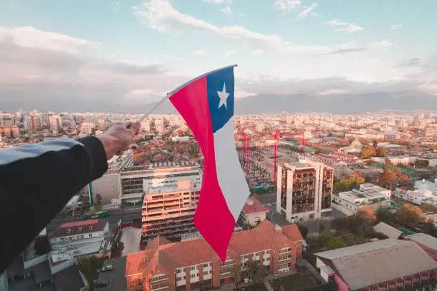 The chilean flag with a beautiful view pf Santiago city.