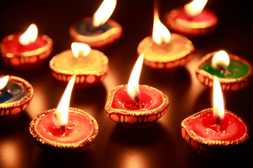 A beautiful traditional Diwali lamps with background blur effects of colorful lighting.