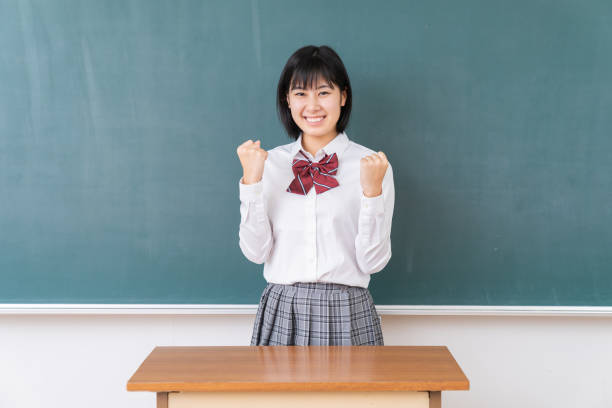 istock young asian school girl,blackboard 1340176846