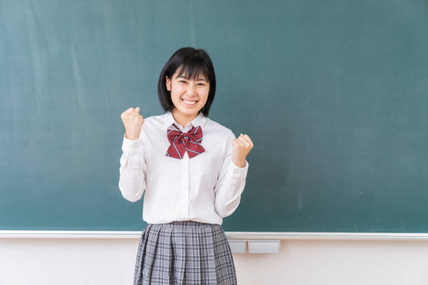 istock young asian school girl,blackboard 1340176936
