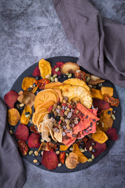 istock Dried fruits and vegetables, dehydrated persimmon, watermelon, pineapple, beetroot chips 1340177110