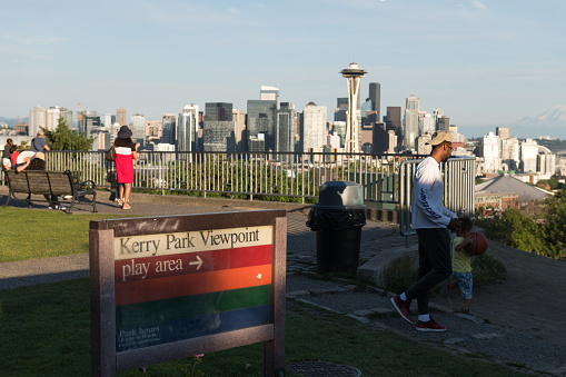 Seattle, USA - Jun 22nd, 2021: Tourists visiting Kerry Park early late in the day with a view of the Seattle Skyline.