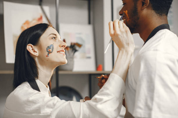 istock Mixed couple painting picture in workshop 1340179688