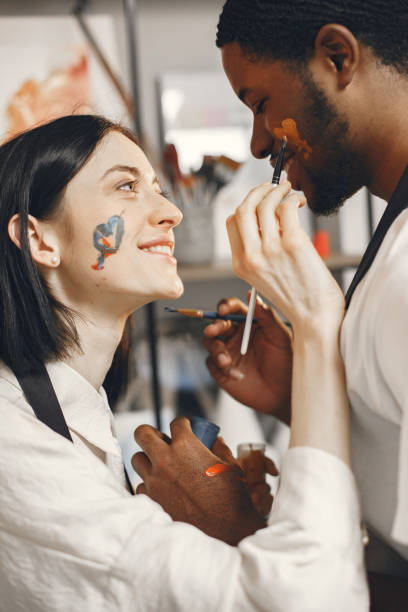 istock Mixed couple painting picture in workshop 1340179695