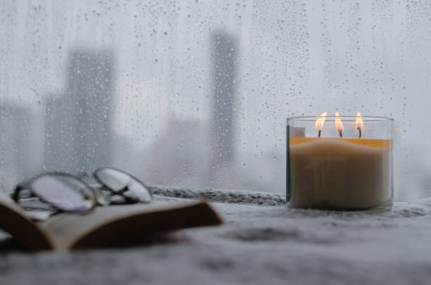 istock Burning aroma candle puts near by window 1340180157