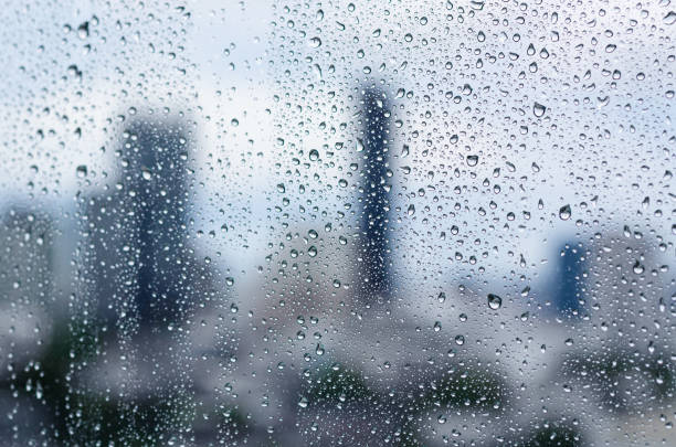 istock Rain drop on glass window at day time in monsoon season 1340180199