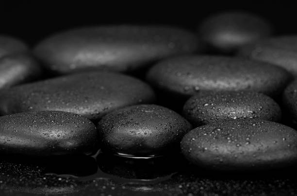 istock black stones with drops on black background black pebbles 1340186527