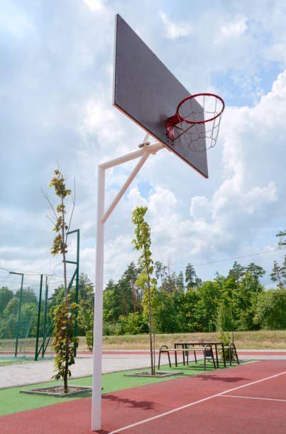 istock Basketball pole with a basket in an stadium outdoor. Vertical view. Low angle view 1340186553