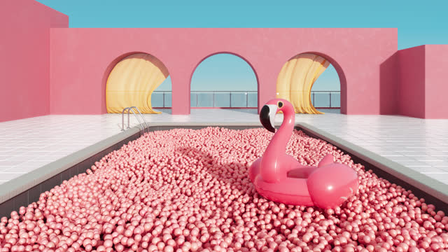Inflatable tropical flamingo floating in the pool filled with thousands of pink rubber balls.