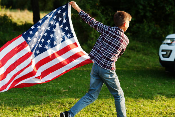 istock Boy with USA flag outdoor 1340188443