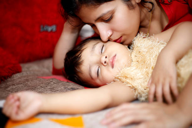 baby sleeping with mother's hand