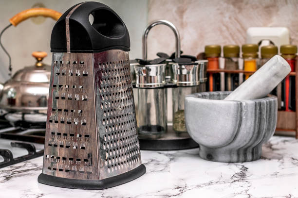 on the marble surface of the kitchen set there are utensils for cooking all kinds of variations of spices for dishes