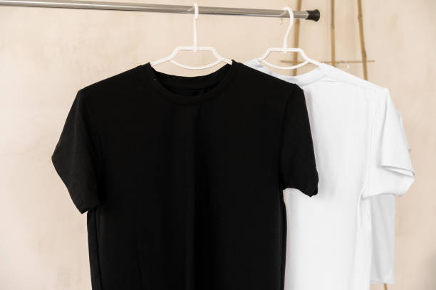 istock White and black T-shirts on hangers for design presentation 1340192160