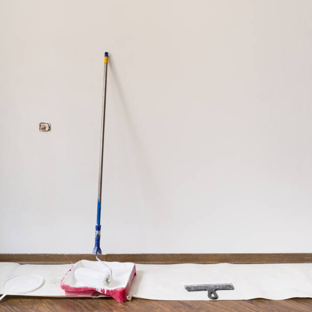 istock Painting white wall at home. Painting tools and materials 1340193120