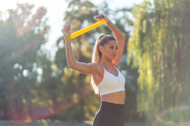 istock Young woman exercising in park 1340193510