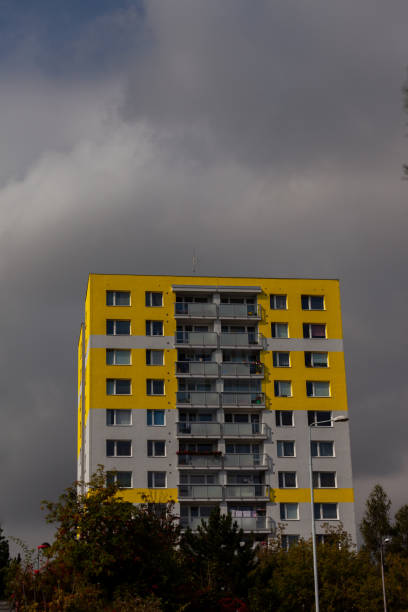 istock A yellow building and dark clouds 1340194882