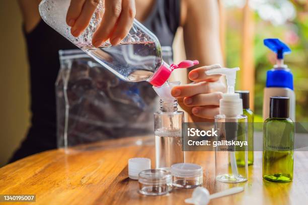 Travel Kit For Transporting Cosmetics On An Airplane Cosmetics Are Ready To Be Poured Into Small Bottles A Woman Shifts Cosmetics To Take With Her Stock Photo - Download Image Now