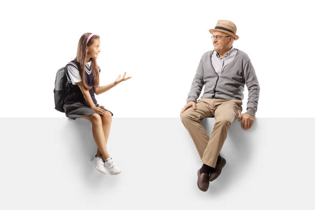istock Schoolgirl sitting on a panel and talking to an elderly man 1340195204