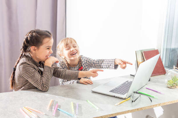 istock two little girls studying online. Distance Learning Online, e-learning, concept 1340195362