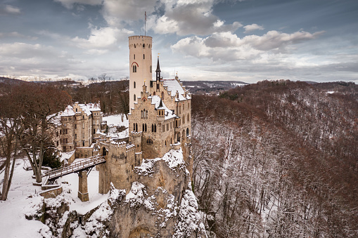 Niedzica, Poland - February 14, 2022:  Medieval castle in Niedzica, dating back to 14th century (upper castle) in winter. Frozen artificial Czorsztyn lake on Dunajec river