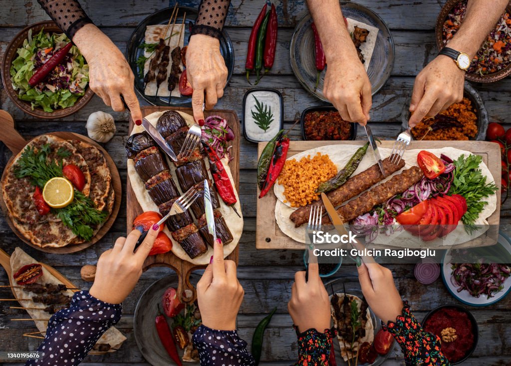 Many types of kebap on the table like adana kebabı and patlıcan kebabı Dining table with family and friends. Food Stock Photo