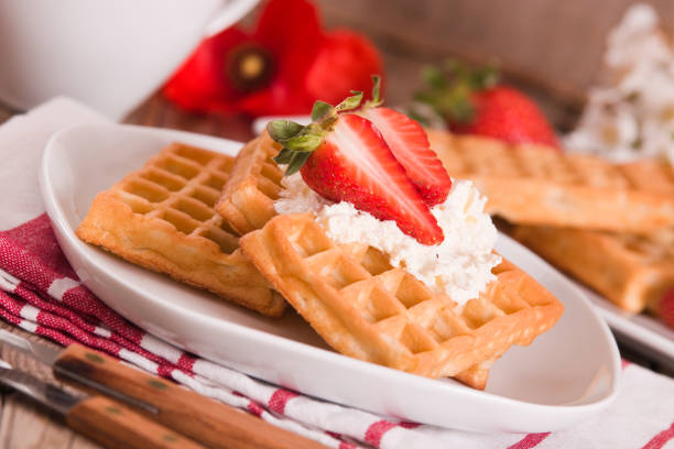 istock Waffles with strawberries and whipped cream. 1340197255