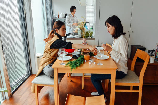 istock Japanese young sisters decorating a Christmas cake together 1340199867