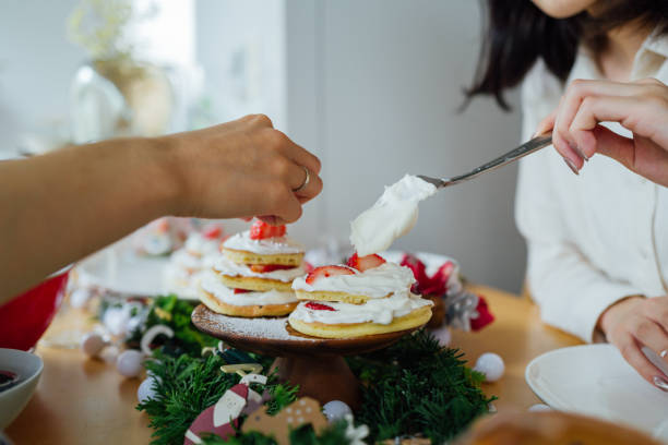 istock Asian sisters decorating a Christmas cake 1340200089